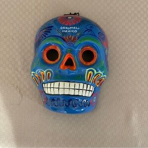 Hand painted souvenir sugar skull from Cozumel, MX in bright blue/multi wall art